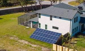 Ground-mounted solar panels in a residential backyard where homeowners need to find property lines