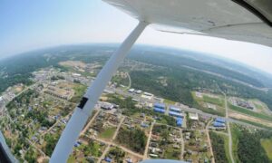 Aerial survey view of storm-damaged neighborhood with visible roof damage and debris