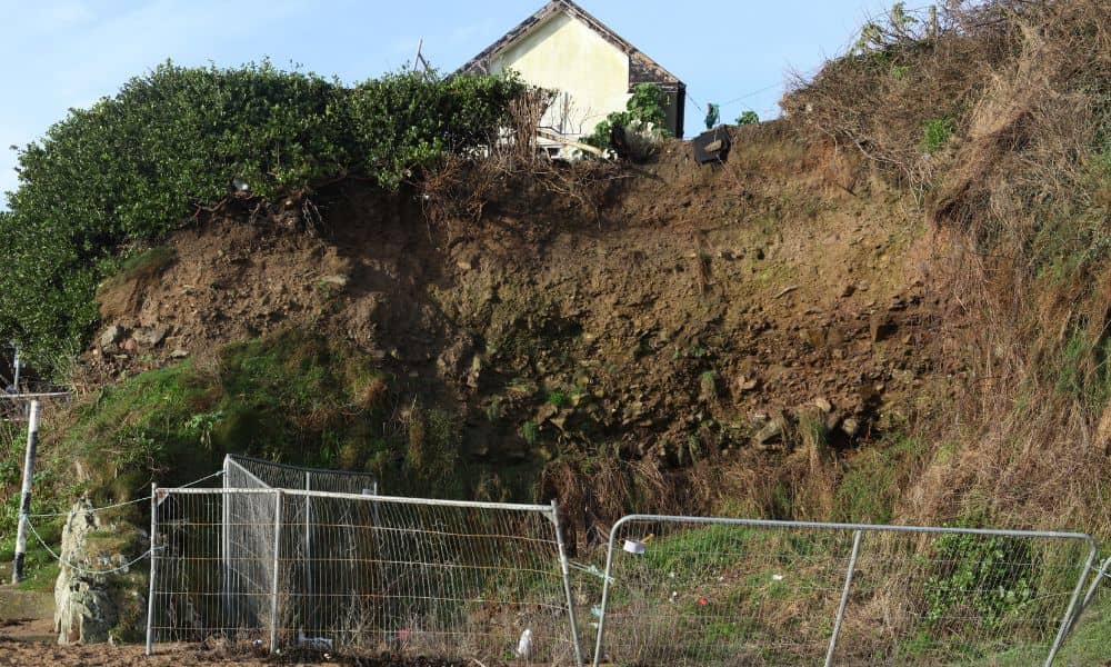 Severe backyard erosion near a property fence showing the importance of boundary surveys to protect land and property boundaries.
