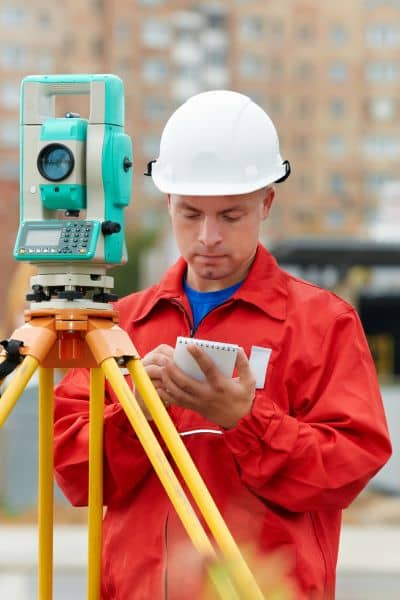 Boundary line surveyor working - ALTA SURVEY Oklahoma Licensed land surveyor using surveying equipment to perform a boundary line survey