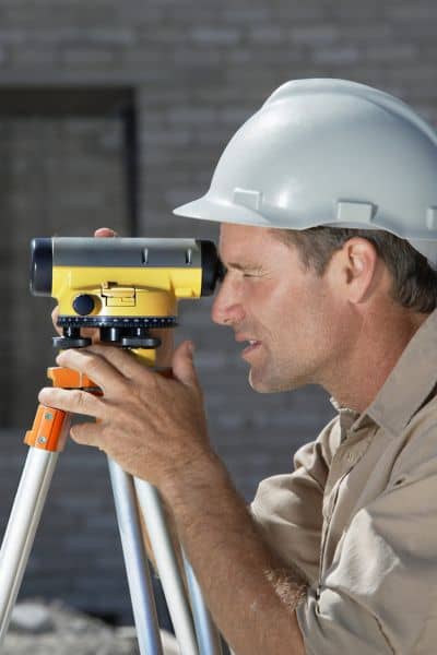Construction surveyor using equipment to support rebuilding with aerial survey data
