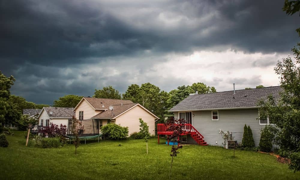 Suburban homes storm clouds 1 - ALTA SURVEY Oklahoma Suburban homes under dark storm clouds showing risk of flooding and importance of checking flood elevation certificate
