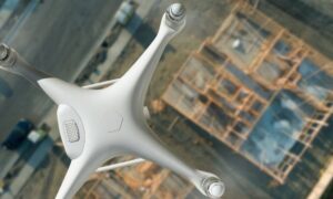 Aerial view drone over construction site - ALTA SURVEY Oklahoma A drone surveying a construction site from above, capturing images for mapping after recent tech updates