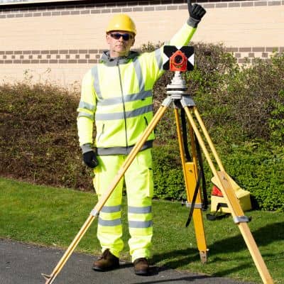 A land survey company using a total station for precise field measurements