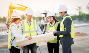 Project team reviewing site plans during an ALTA land survey for a commercial development project