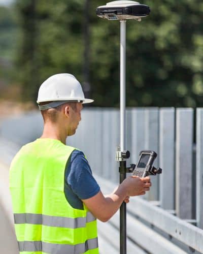 Surveyor using gps rover for land measurement - ALTA SURVEY Oklahoma Surveying companies using GPS rover equipment to collect accurate property measurements in the field