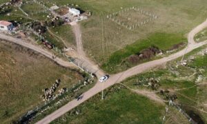Aerial view of a rural road and farmland where a boundary survey can help establish property lines